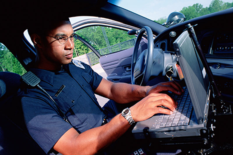 Police officer working on a computer