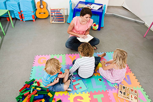Daycare teacher with a group of children
