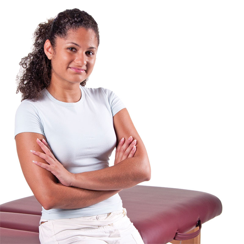 Massage Therapist standing beside a massage table