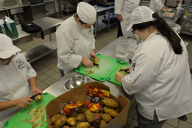 Culinary Students peeling potatoes